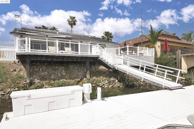 view of dock with a deck with water view