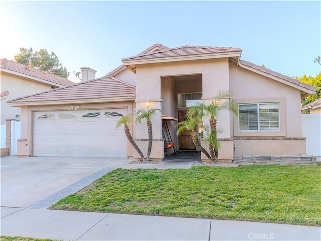 view of front of home with a garage and a front lawn