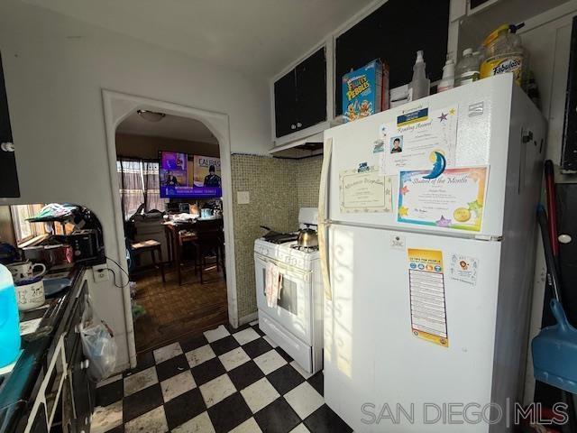 kitchen with tasteful backsplash and white appliances