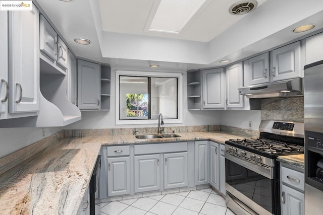 kitchen featuring sink, gray cabinets, light stone countertops, and appliances with stainless steel finishes