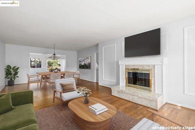 living room with wood-type flooring and a fireplace