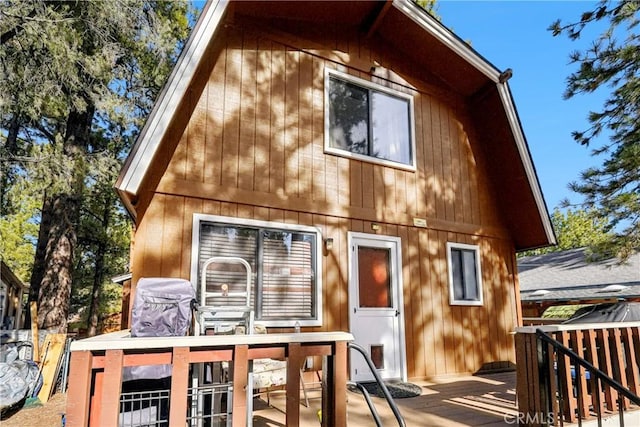 rear view of property with a wooden deck