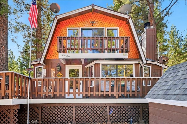 rear view of property featuring a deck