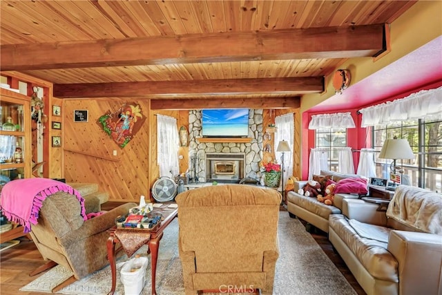 living room with beamed ceiling, wood ceiling, and wooden walls