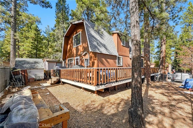 back of house with a wooden deck