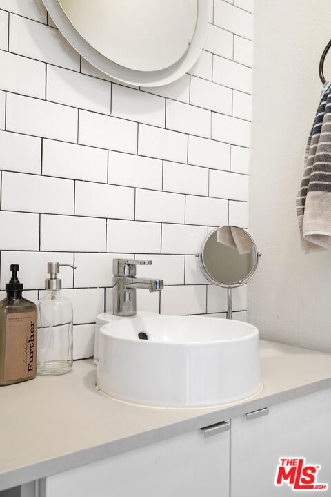 bathroom featuring vanity, tile walls, and decorative backsplash