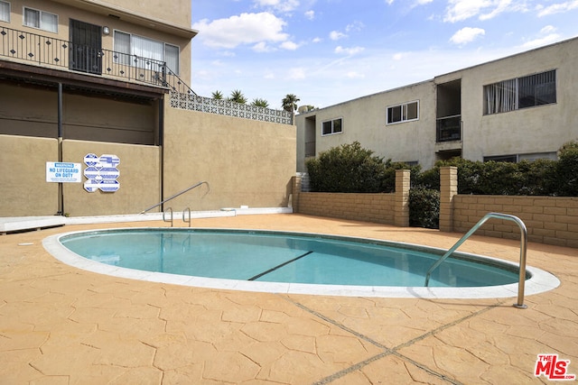 view of swimming pool featuring a patio area