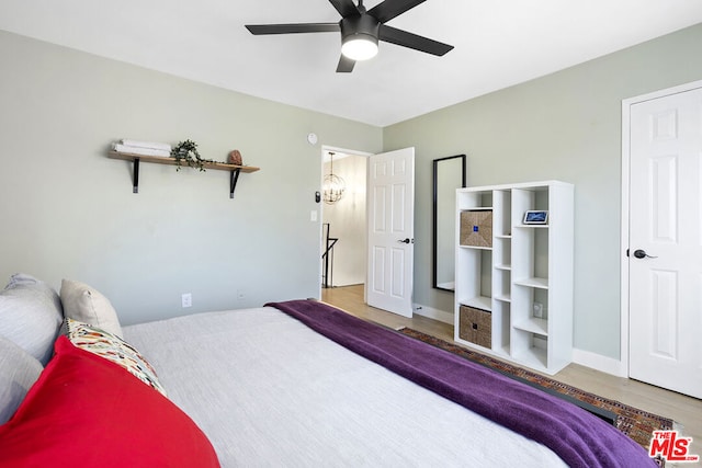 bedroom featuring ceiling fan and hardwood / wood-style flooring