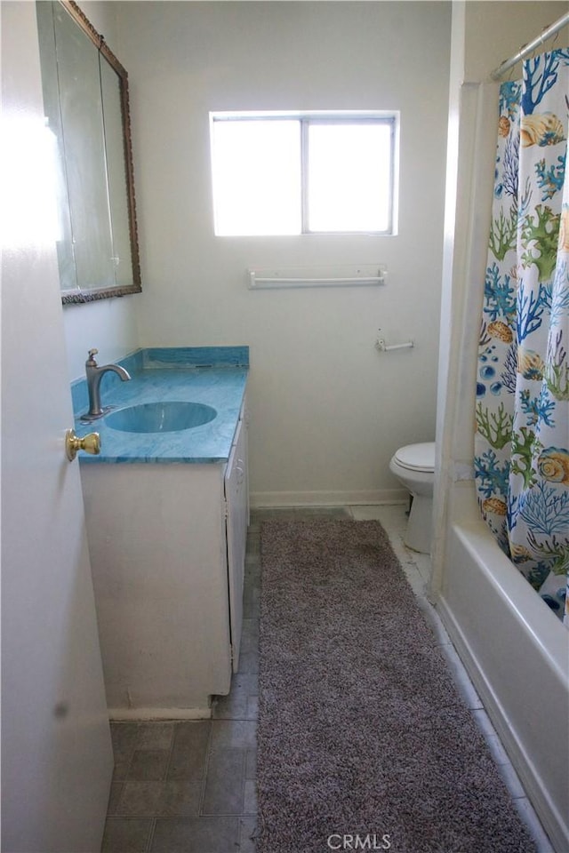 full bathroom with vanity, shower / tub combo, and toilet