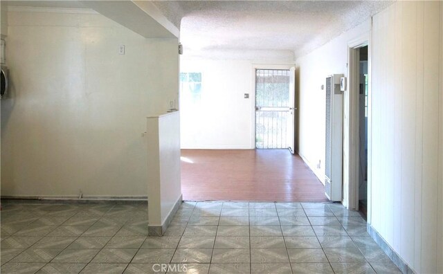 hallway with a textured ceiling