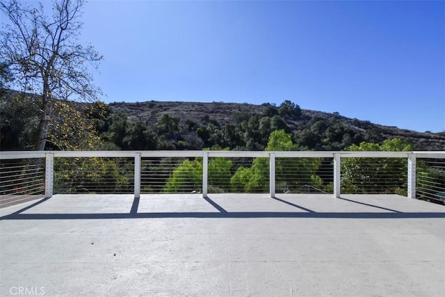 view of patio featuring a deck with mountain view