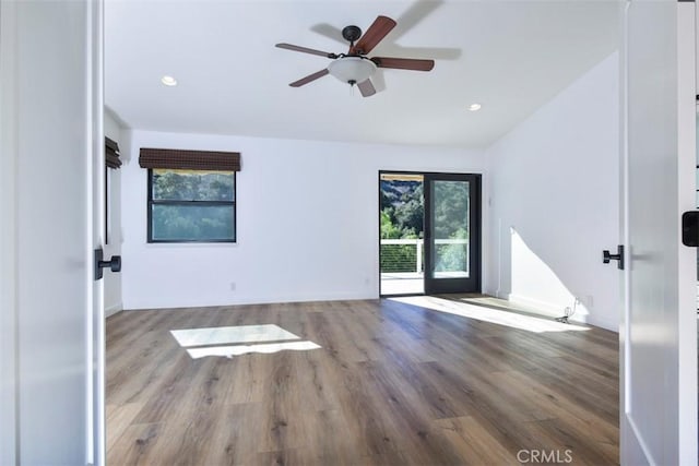 unfurnished room with ceiling fan and hardwood / wood-style floors