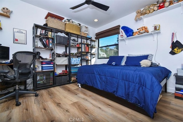 bedroom with ceiling fan and wood-type flooring