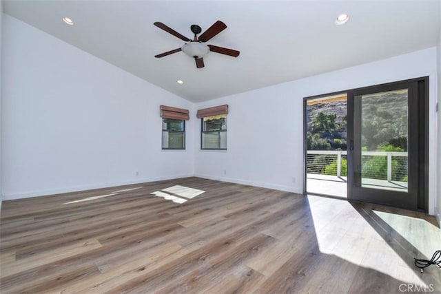 unfurnished room featuring wood-type flooring, vaulted ceiling, and ceiling fan