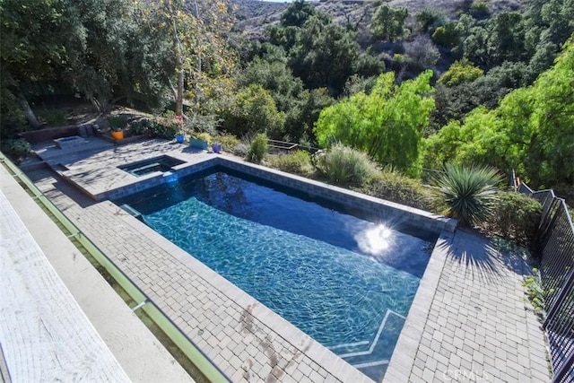 view of pool featuring an in ground hot tub and a patio