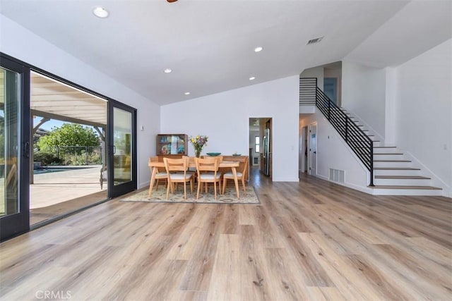 unfurnished dining area featuring light hardwood / wood-style floors and vaulted ceiling