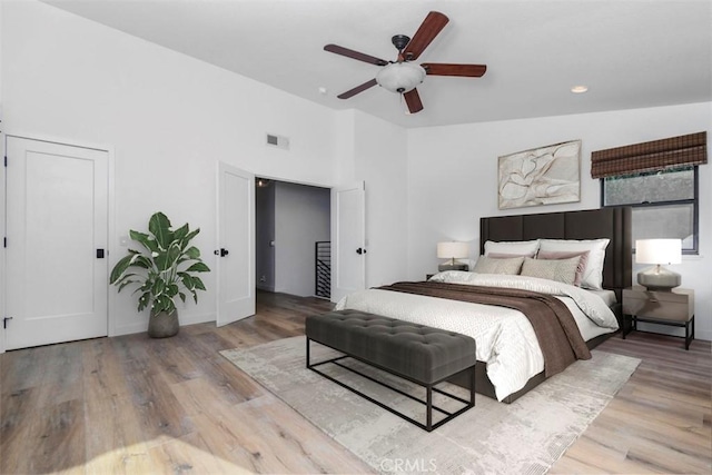 bedroom featuring lofted ceiling, light hardwood / wood-style floors, and ceiling fan