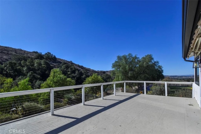 view of patio with a balcony and a mountain view