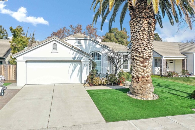 view of front of house featuring a garage and a front lawn