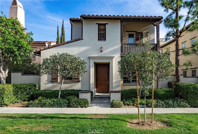 mediterranean / spanish home with a front lawn