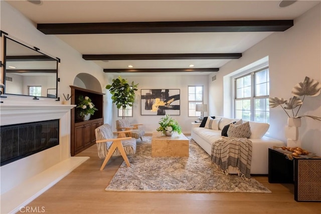 living room featuring light hardwood / wood-style floors and beam ceiling