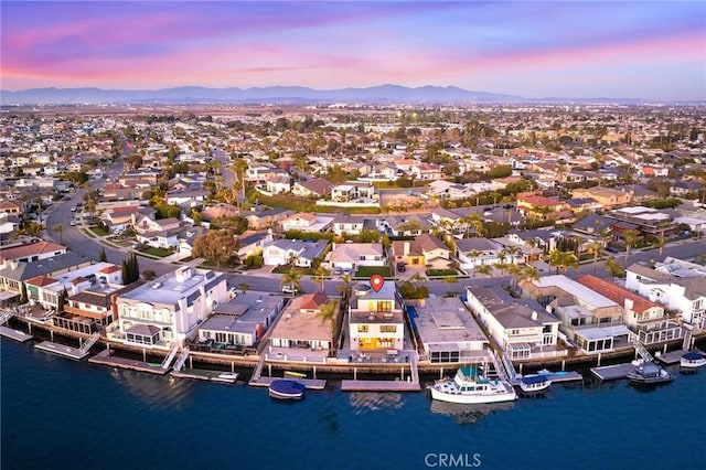 aerial view at dusk with a water and mountain view