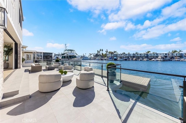 view of patio featuring a balcony and a water view