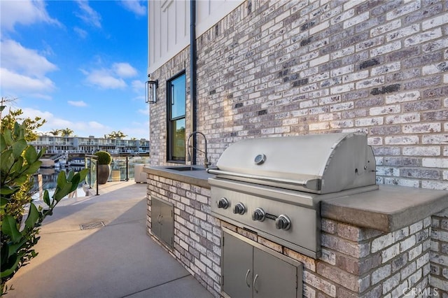 view of patio featuring sink, exterior kitchen, and area for grilling