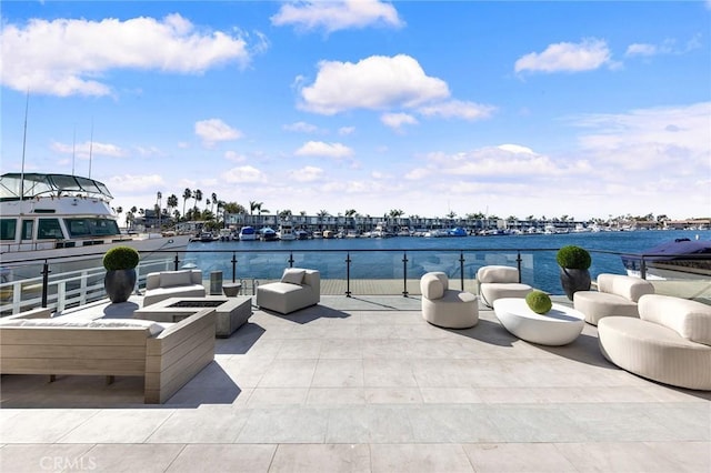 view of patio featuring a water view and a fire pit