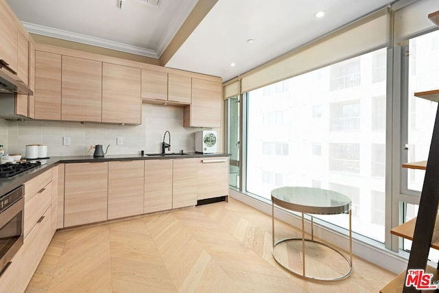 kitchen featuring oven, crown molding, sink, light parquet flooring, and light brown cabinets