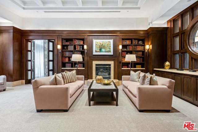 living room with built in features, light colored carpet, and wooden walls