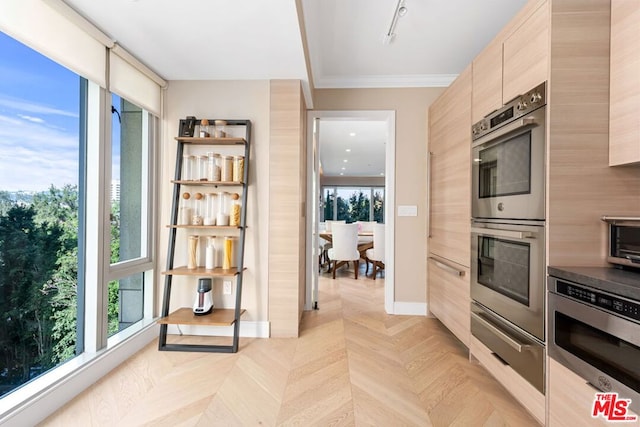 kitchen with a wealth of natural light, appliances with stainless steel finishes, light parquet floors, ornamental molding, and light brown cabinets