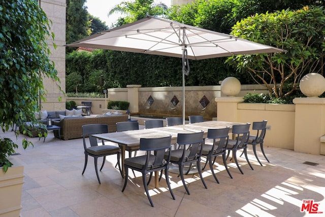 view of patio featuring outdoor lounge area and a bar