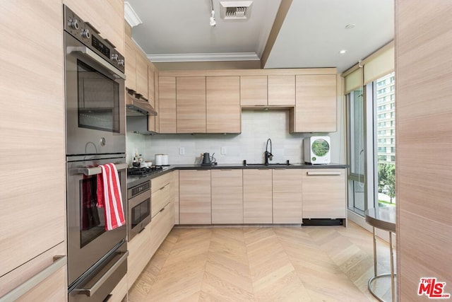 kitchen with light brown cabinetry, crown molding, sink, light parquet floors, and stainless steel appliances