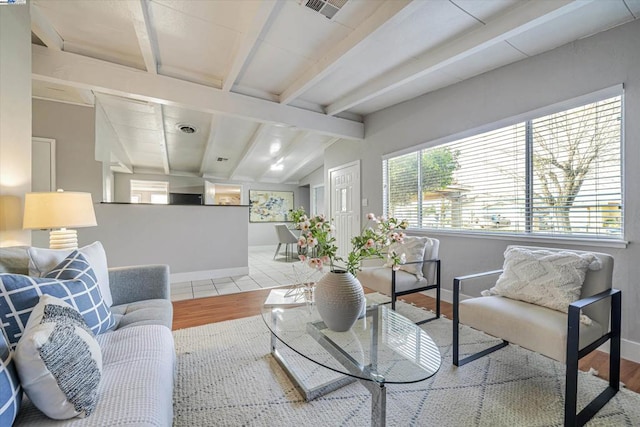 living room featuring light hardwood / wood-style floors and lofted ceiling with beams