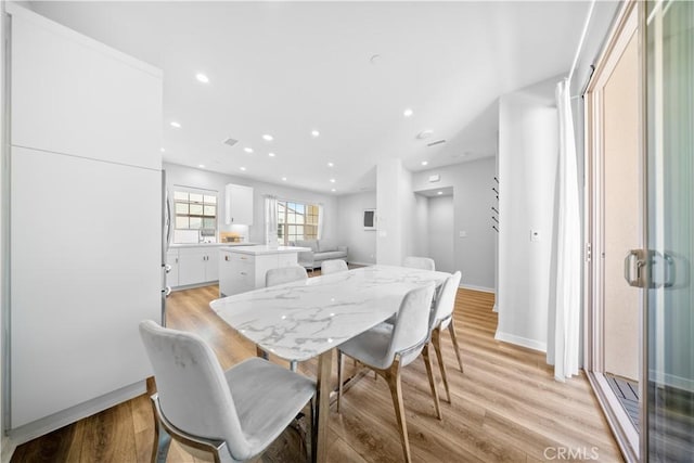 dining space with light wood-type flooring