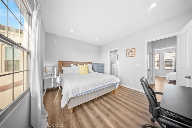 bedroom featuring hardwood / wood-style floors and ensuite bath