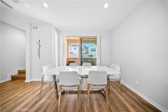 dining space with hardwood / wood-style floors