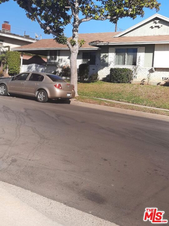 view of front of property with a front yard and a carport