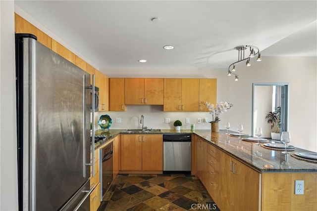 285 W 6th St Unit 426, San Pedro, CA 90731 - kitchen featuring appliances with stainless steel finishes, a peninsula, dark stone counters, recessed lighting, and dark stone finish floors