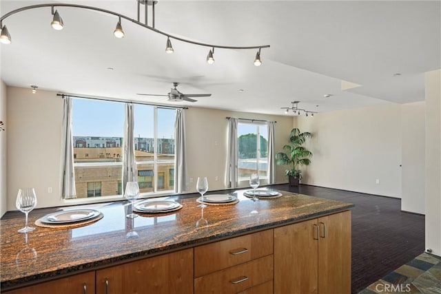 285 W 6th St Unit 426, San Pedro, CA 90731 - kitchen with a ceiling fan, open floor plan, brown cabinets, and dark stone counters
