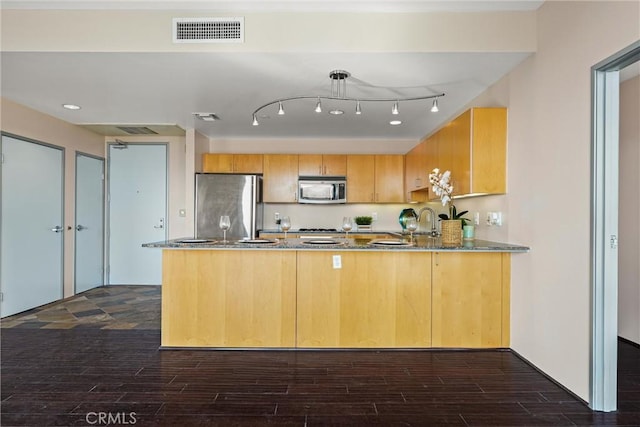 285 W 6th St Unit 426, San Pedro, CA 90731 - kitchen featuring appliances with stainless steel finishes, a peninsula, dark wood-style flooring, and light stone counters