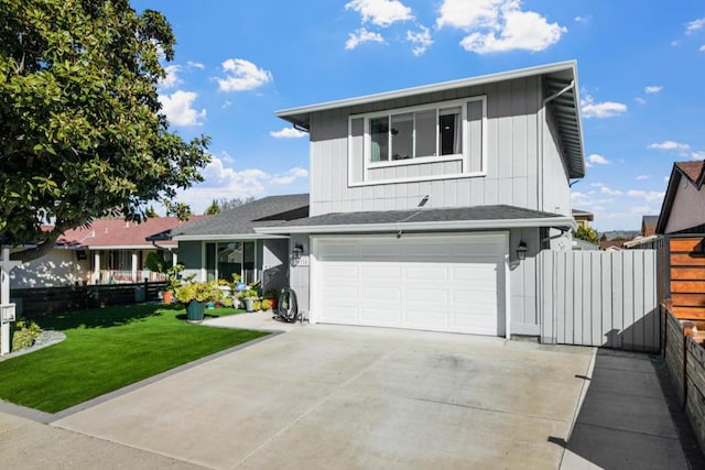 view of front of property with a garage and a front lawn