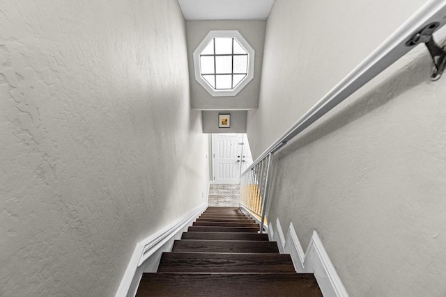 stairway featuring a high ceiling