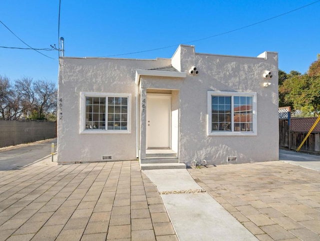 pueblo-style home with a patio area