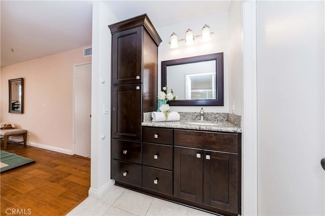 bathroom featuring hardwood / wood-style flooring and vanity