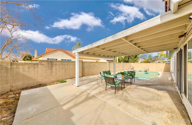 view of patio / terrace with a fenced in pool