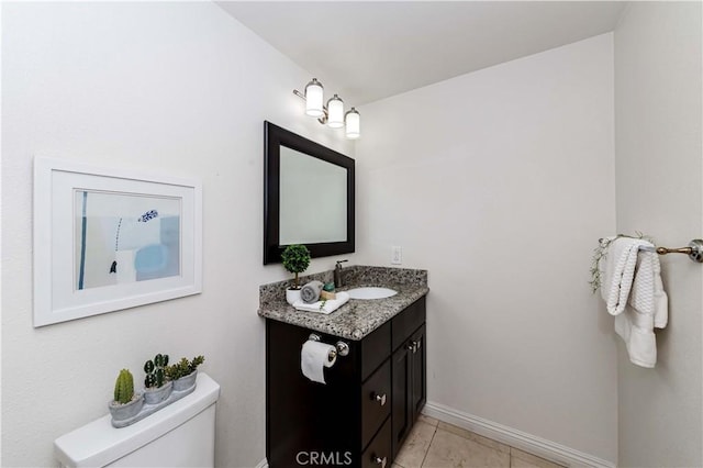 bathroom featuring toilet, vanity, and tile patterned flooring