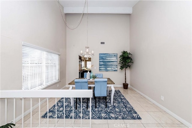 dining room with a high ceiling, a notable chandelier, and tile patterned flooring