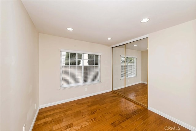 empty room with hardwood / wood-style floors